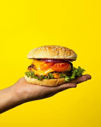 Delicious Cheeseburger on a Hand