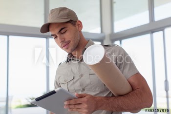 Deliveryman with digital tablet and tube package