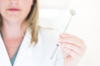 Dentist Holding Dental Tool