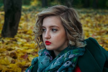 Depth of Field Photography of Woman With Green and White Floral Chiffon Fabric Scarf