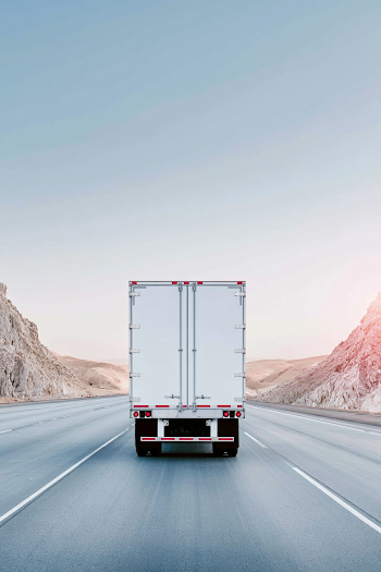 Desert Highway Journey: Rear View of a White Box Trailer Truck