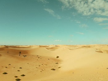 Desert Land and Sand Dunes Under Blue Sky