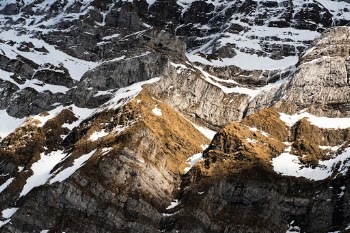 detail view of the stone structure of a mountain range in Switzerland during spring with left over snow
