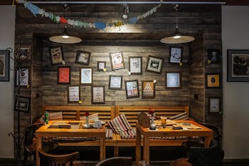 Dinning Tables Near Wall With Photo Frame Decor