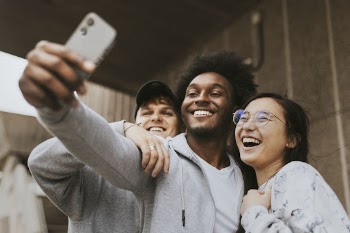 Diverse friends taking selfie from phone | Free Photo - rawpixel