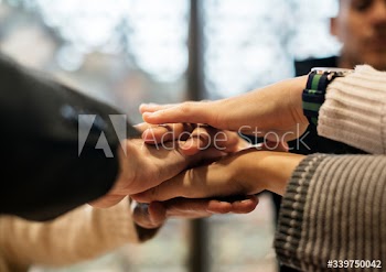 Diverse people stacking hands together