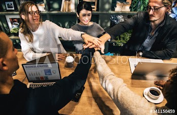 Diverse people stacking hands together