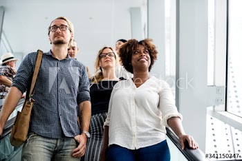 Diverse people taking an escalator
