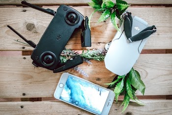 Dji Controller Beside Iphone