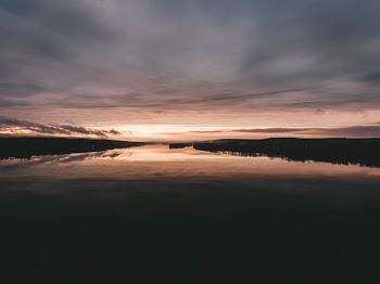 dock reflecting on body of water