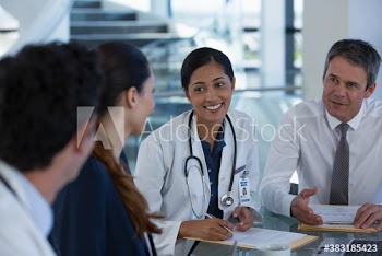 Doctor and hospital administrators talking in meeting