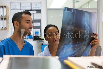 Doctor and nurse discussing x-ray in clinic