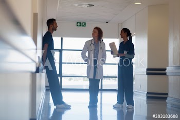 Doctor and nurses consulting in hospital corridor