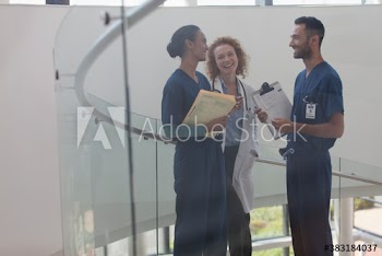 Doctor and nurses talking on hospital staircase