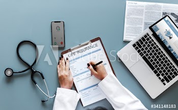 Doctor filling up a life insurance form