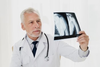 Doctor looking at x-ray Free Photo