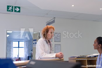 Doctor talking with nurse at hospital nurses station