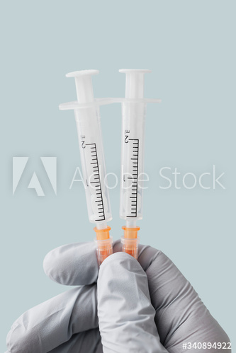 Doctor wearing latex gloves holding syringes mockup