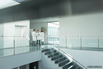 Doctors consulting in hospital corridor