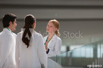Doctors in lab coats consulting
