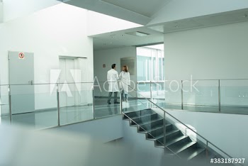 Doctors shaking hands in hospital corridor