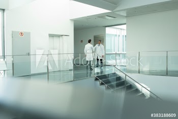 Doctors shaking hands in hospital corridor