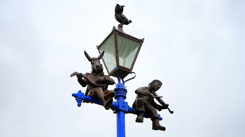 Donkey and Man Playing Instrument in Street Lights