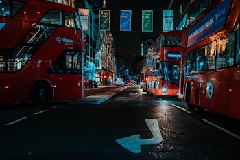 double decker buses on road at night