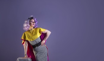 Drag Queen Performer Leans On Table Pose