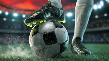 Dramatic Close-Up of Soccer Player's Cleat on a Worn Ball