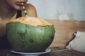 Drinking a fresh young coconut water 