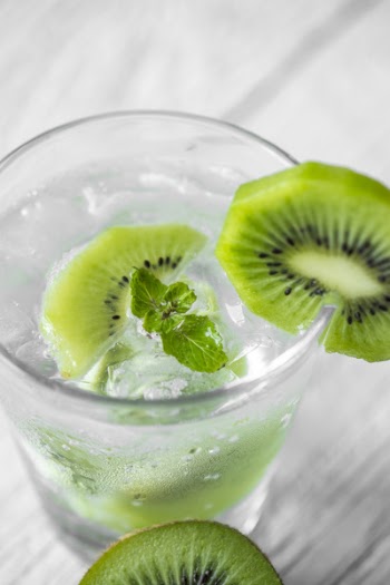 Drinking Glass Filled With Liquid With Sliced Kiwis