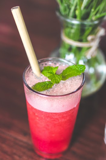 Drinking Glass With Pink Beverage And Mint Leaves