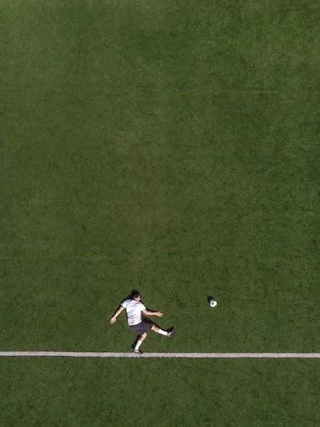 Drone Birds Eye Photo of Striker Kicking Portrait