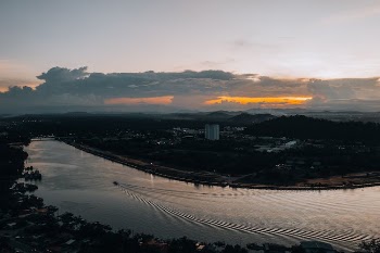 Drone Shot of a Watercraft on Traveling a River during Sunset