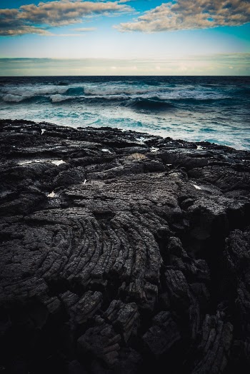 Dusk over a field of lava bordering the Pacific Ocean in Hawaii, USA.