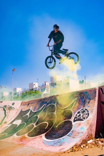 Dynamic BMX Rider Performing Stunt with Colorful Smoke