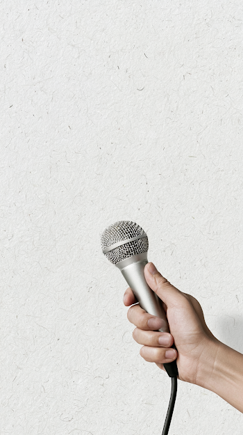 Dynamic Silver Microphone Held by a Human Hand