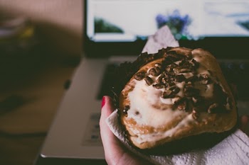          Eating Muffin on Laptop Free Photo     