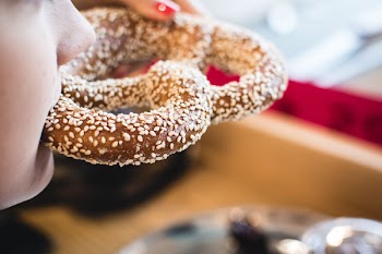 Eating pretzel with sesame seeds 