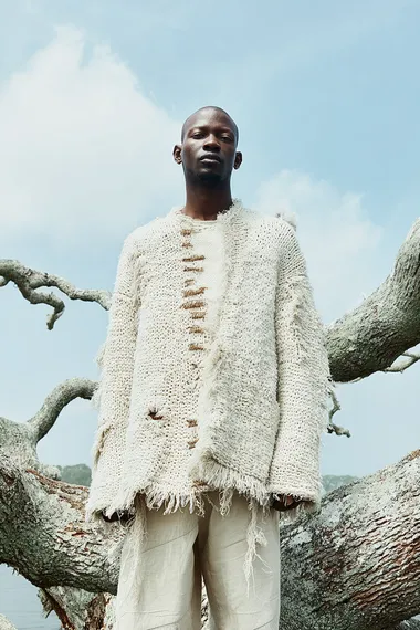 Eco-Chic Fashion Editorial with Black Male Model on Tree Trunk Eco-Chic Fashion Editorial with Black Male Model on Tree Trunk