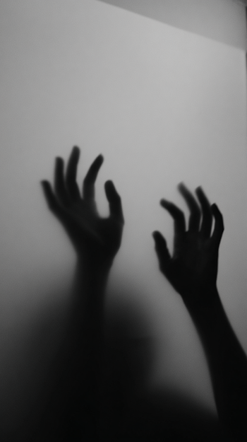 Eerie Hands Behind Foggy Glass