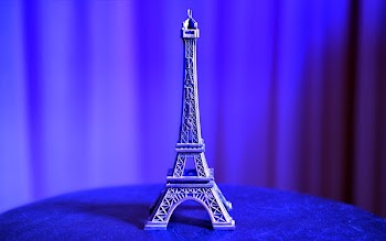 Eiffel Tower Miniature on Blue Textile