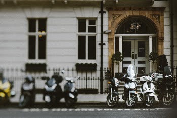 Eight Assorted Motorcycles Parked on Concrete Floor