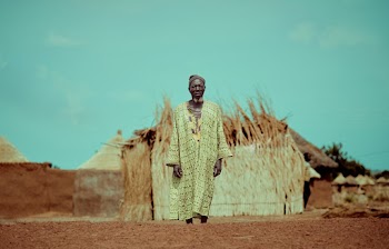 Elderly Man Standing Near Structure