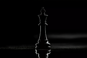 Elegant Black Chess King on Reflective Surface