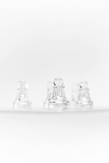 Elegant Clear Glass Bells on White Background