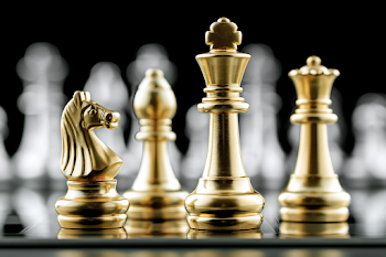 Elegant Gold Chess Pieces on Glossy Board