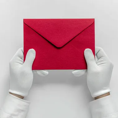 Elegant Red Envelope Held by Gloved Hands