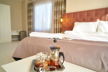Empty Bed Near Table With Tea